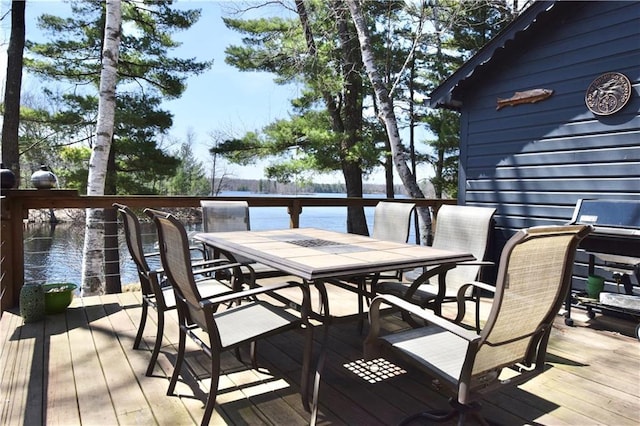 wooden deck featuring outdoor dining area