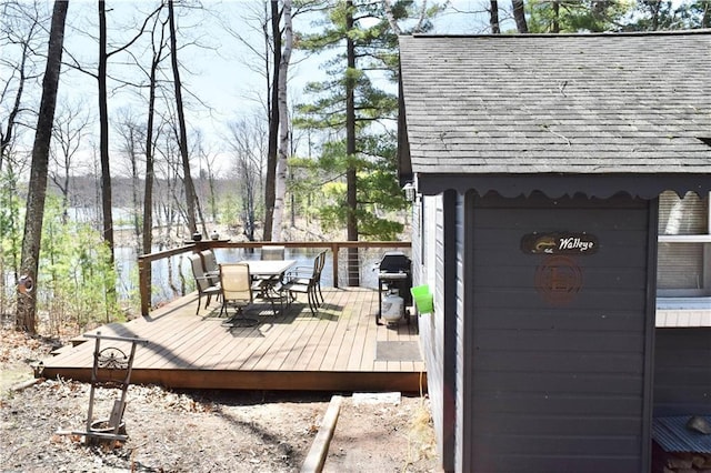 wooden terrace with area for grilling and outdoor dining area