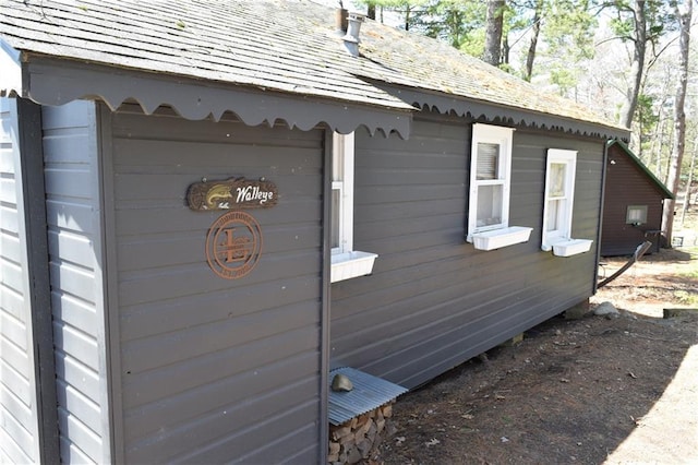 view of home's exterior featuring roof with shingles