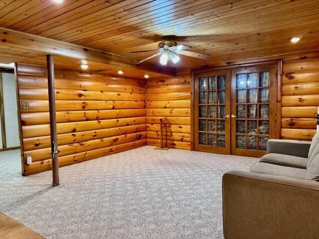 sitting room featuring carpet floors, a ceiling fan, wood ceiling, and log walls