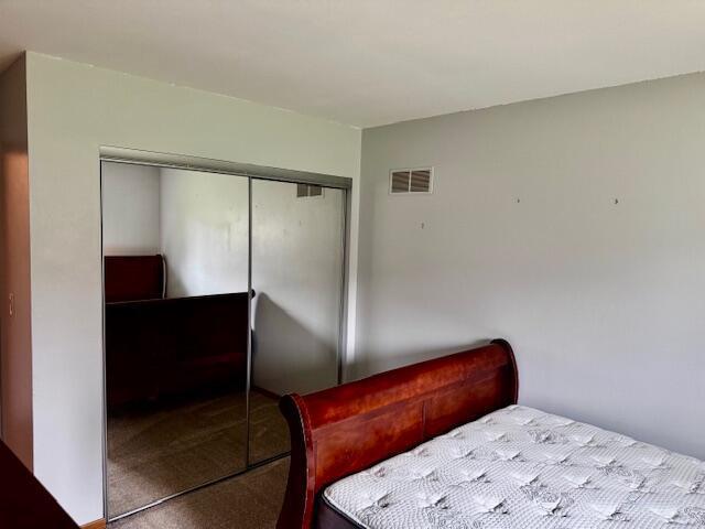 bedroom with a closet and visible vents