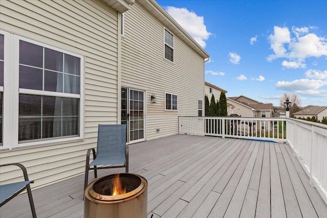 630 Polaris St, West Bend, WI 53095 - wooden terrace featuring an outdoor fire pit and a residential view
