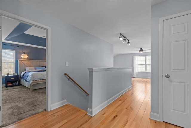 630 Polaris St, West Bend, WI 53095 - hall with baseboards, an upstairs landing, and light wood-type flooring