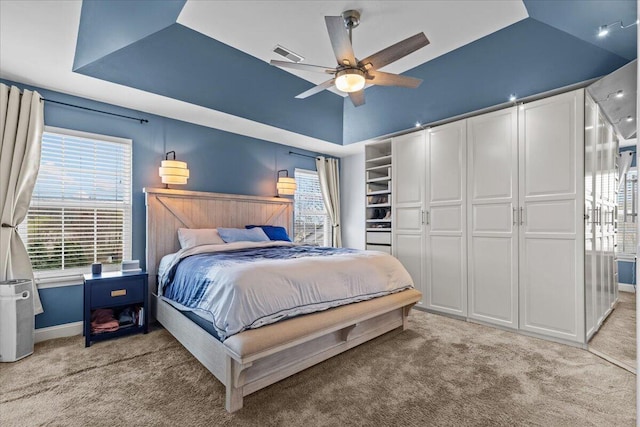 630 Polaris St, West Bend, WI 53095 - bedroom with multiple windows, a tray ceiling, and light colored carpet