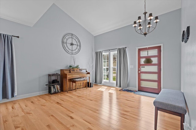 630 Polaris St, West Bend, WI 53095 - foyer with an inviting chandelier, light wood finished floors, baseboards, and high vaulted ceiling