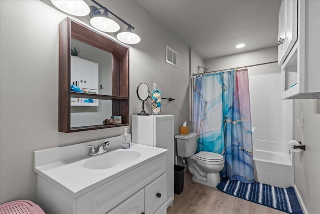 630 Polaris St, West Bend, WI 53095 - full bathroom featuring visible vents, vanity, wood finished floors, shower / bath combination with curtain, and toilet