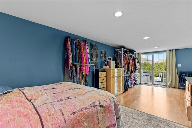 630 Polaris St, West Bend, WI 53095 - bedroom with recessed lighting, access to exterior, and wood finished floors