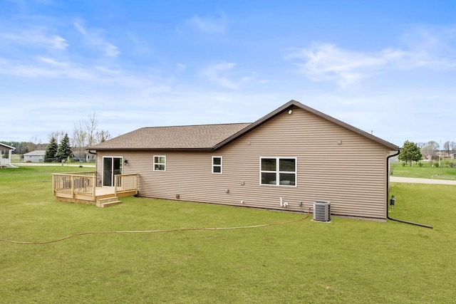 back of property featuring central air condition unit, a shingled roof, a yard, and a deck