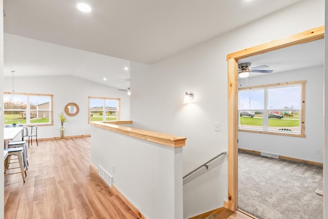 hallway with visible vents, recessed lighting, and an upstairs landing