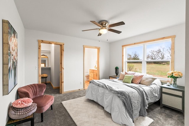 bedroom with baseboards, light colored carpet, ceiling fan, and ensuite bathroom