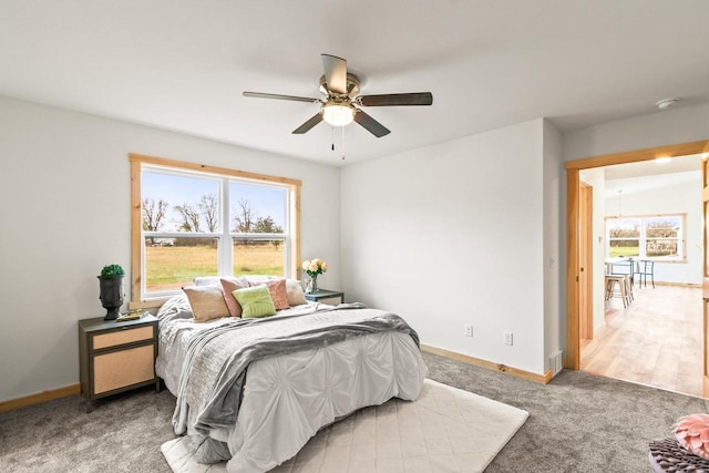 bedroom featuring carpet floors, a ceiling fan, and baseboards