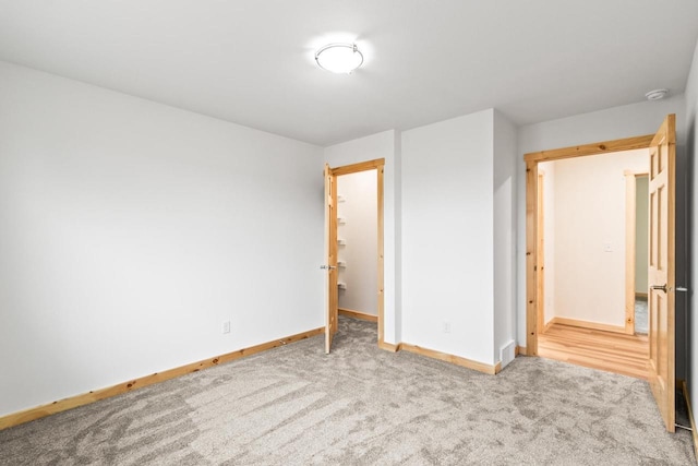 unfurnished bedroom featuring baseboards and carpet flooring