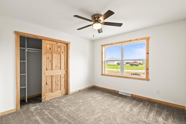 unfurnished bedroom featuring visible vents, a closet, baseboards, a ceiling fan, and carpet
