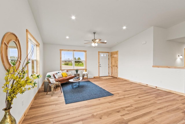 living area with recessed lighting, baseboards, vaulted ceiling, and light wood-type flooring