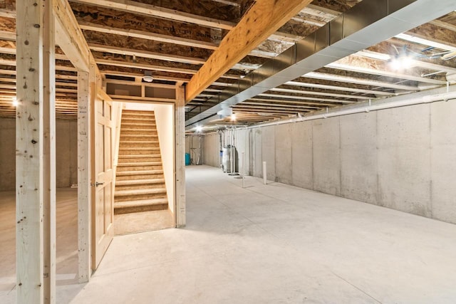 unfinished basement featuring stairway