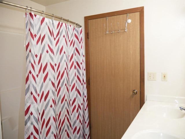 bathroom with a sink and curtained shower