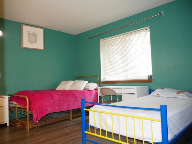 bedroom featuring wood finished floors