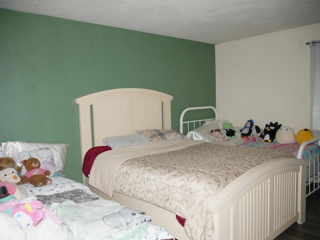bedroom with wood finished floors