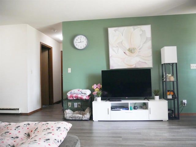 living room featuring baseboards, a baseboard radiator, and wood finished floors