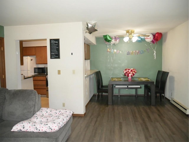 dining space featuring dark wood-type flooring, baseboards, ceiling fan, and baseboard heating