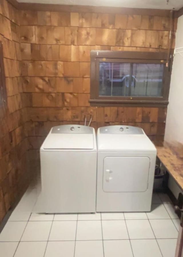 laundry area with laundry area, washer and clothes dryer, and tile patterned floors