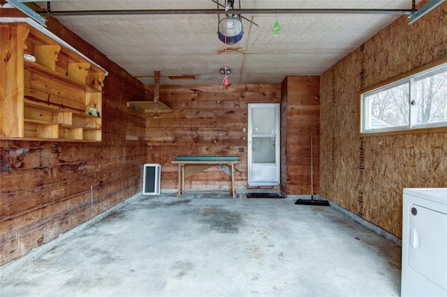 2015 Valmont Ave, Eau Claire, WI 54701 - garage with a garage door opener, washer / dryer, and wooden walls