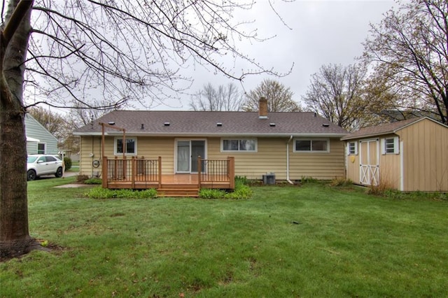 2015 Valmont Ave, Eau Claire, WI 54701 - back of house with a lawn, an outdoor structure, a shed, and a chimney