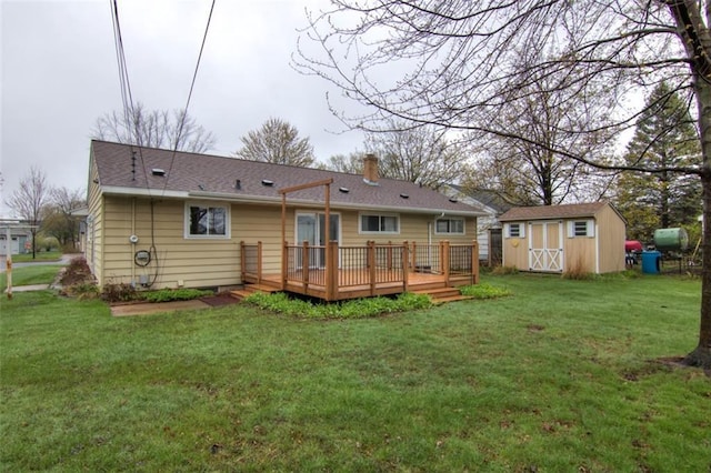 2015 Valmont Ave, Eau Claire, WI 54701 - back of property featuring an outdoor structure, a lawn, a wooden deck, and a shed