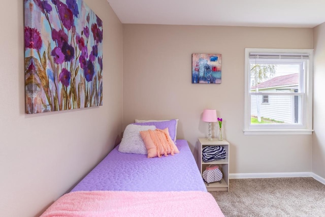 bedroom featuring baseboards and carpet flooring