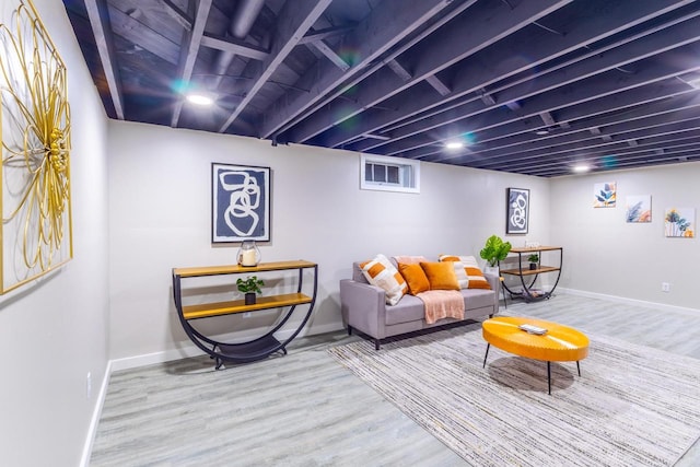 living room with baseboards and wood finished floors