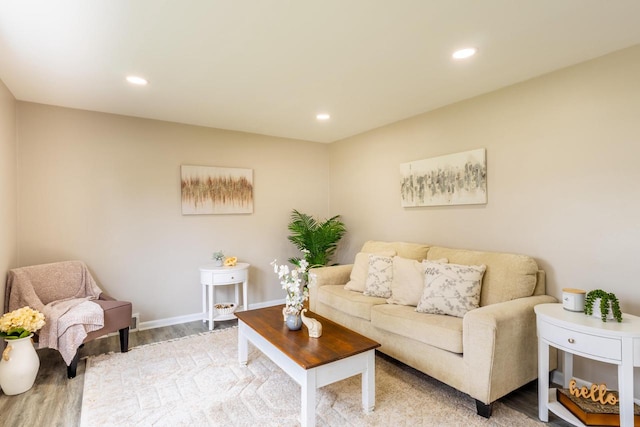 living room with recessed lighting, light wood-style flooring, and baseboards