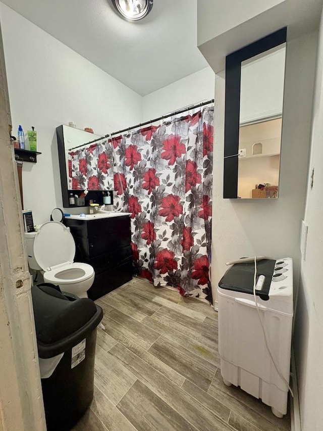 full bathroom featuring vanity, wood finished floors, toilet, and a shower with curtain