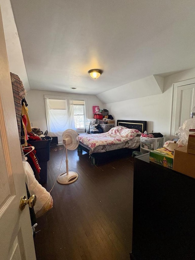 bedroom featuring wood-type flooring and lofted ceiling