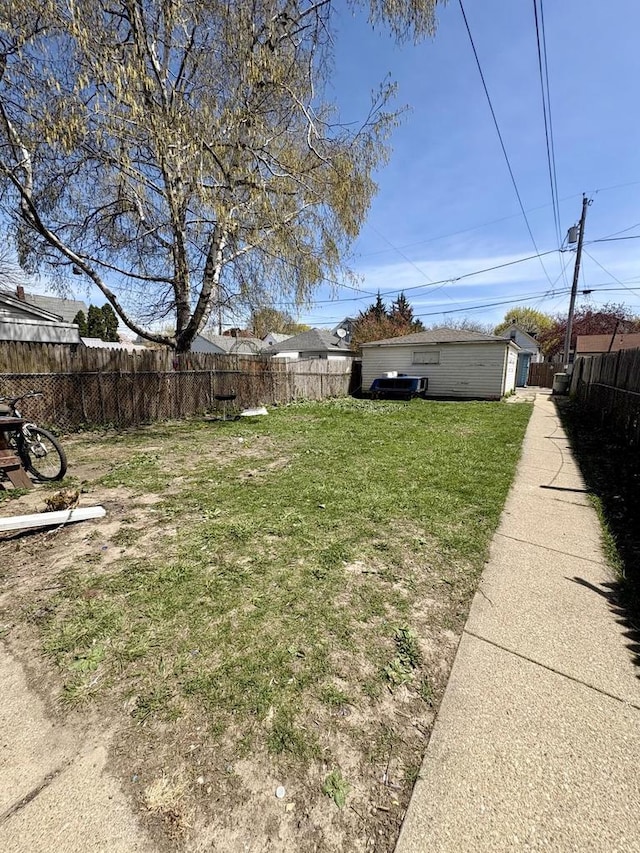 view of yard with fence and an outdoor structure