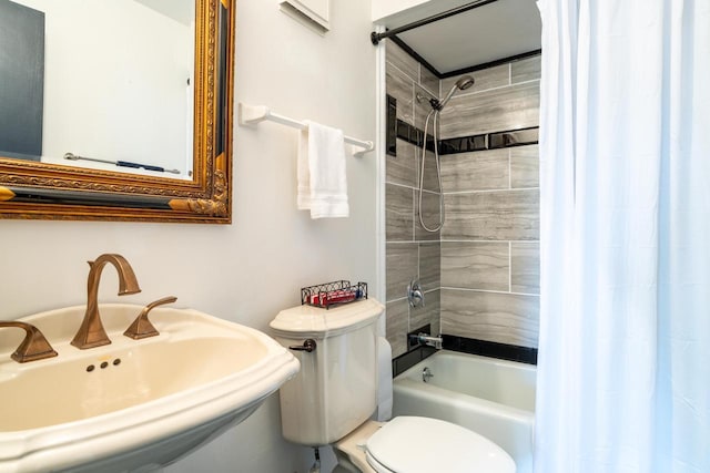 bathroom with a sink, shower / bathtub combination with curtain, and toilet
