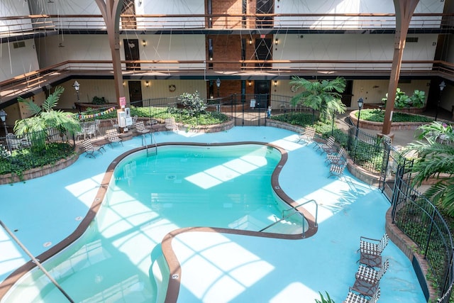 pool featuring fence and a patio