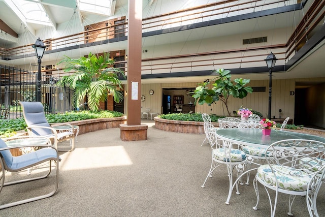 view of patio featuring fence and outdoor dining space