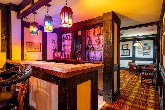 bar with hanging light fixtures and a bar