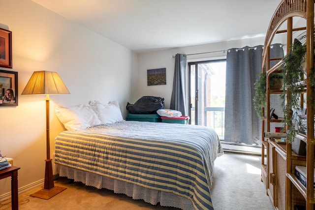 carpeted bedroom with a baseboard heating unit