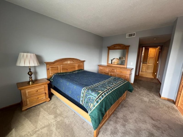 bedroom featuring baseboards, carpet, a textured ceiling, and visible vents