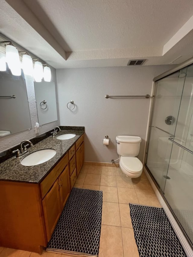 full bath featuring a sink, toilet, and a shower stall