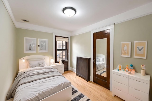 bedroom with visible vents and light wood finished floors
