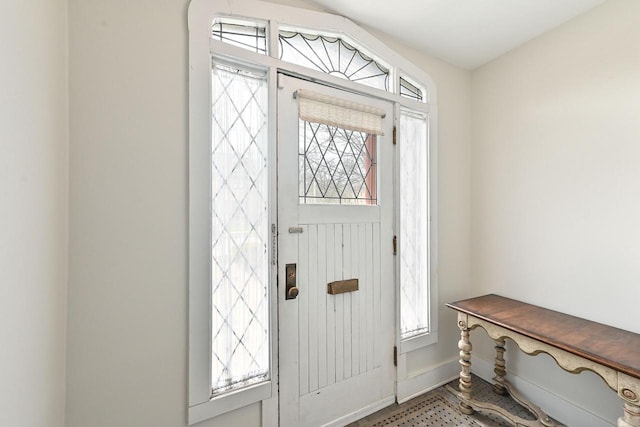 entryway with baseboards and a healthy amount of sunlight