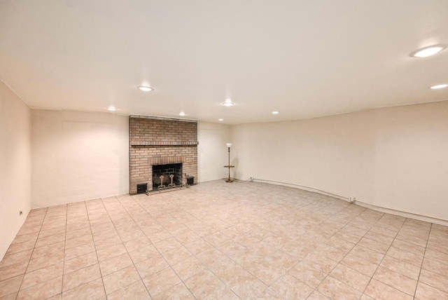 unfurnished living room with a brick fireplace and recessed lighting
