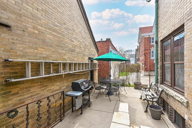 view of patio / terrace featuring fence, outdoor dining space, and area for grilling