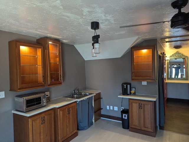 4464 S Whitnall Ave, Milwaukee, WI 53225 - kitchen featuring light countertops, a textured ceiling, baseboards, and a sink