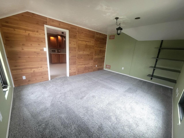 4464 S Whitnall Ave, Milwaukee, WI 53225 - additional living space featuring carpet floors, wood walls, and vaulted ceiling