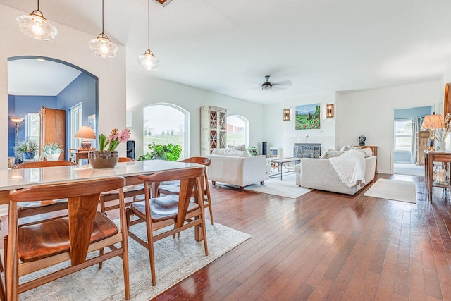 183 Twin Valley Trl, Cedar Grove, WI 53013 - dining area featuring plenty of natural light, arched walkways, a glass covered fireplace, and ceiling fan