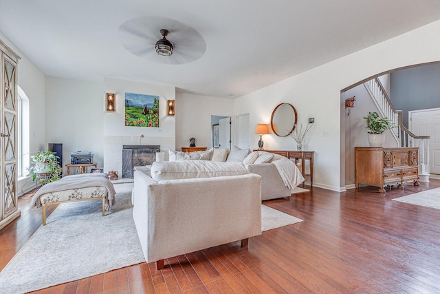 183 Twin Valley Trl, Cedar Grove, WI 53013 - living room with a ceiling fan, dark wood finished floors, a tile fireplace, and stairs
