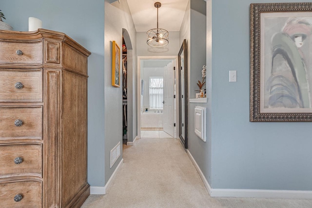 183 Twin Valley Trl, Cedar Grove, WI 53013 - corridor featuring baseboards, arched walkways, and light carpet